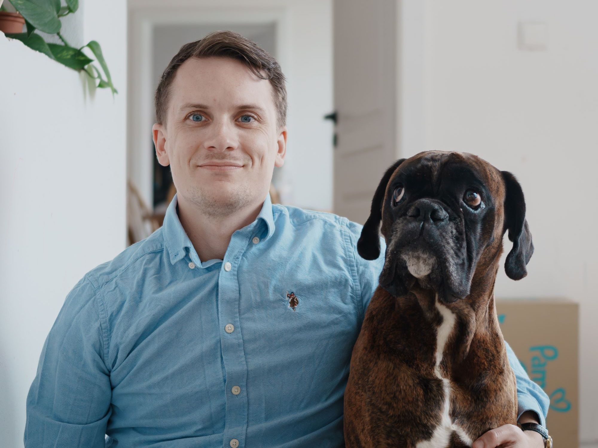 Marcel Janik sitting next to his Boxer Alf